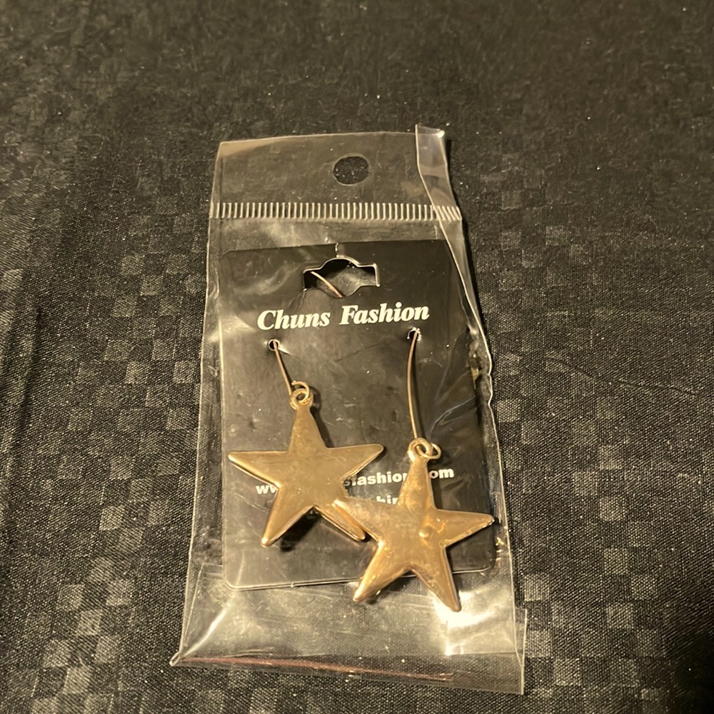 Gold toned star dangle earrings